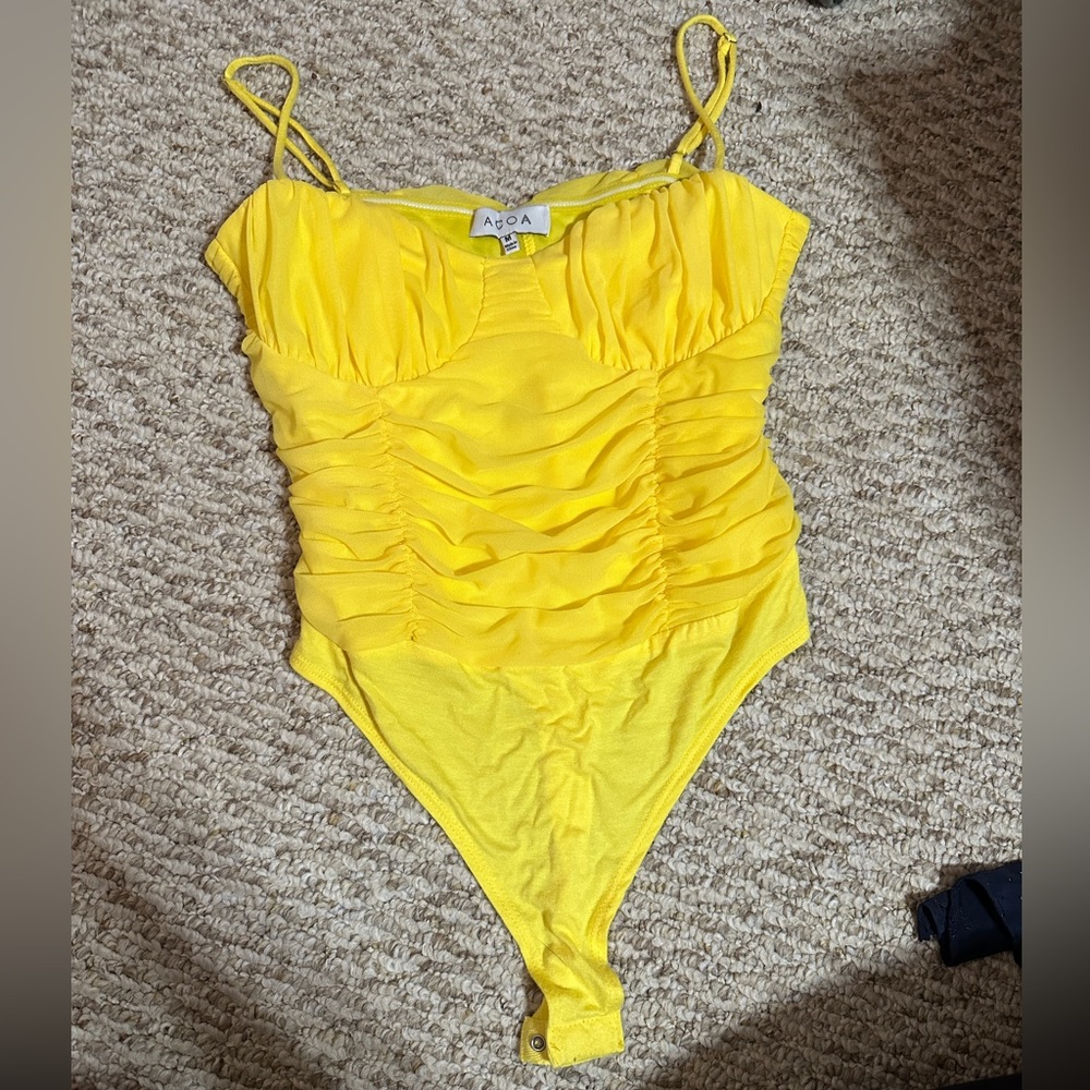 ACOA yellow bodysuit